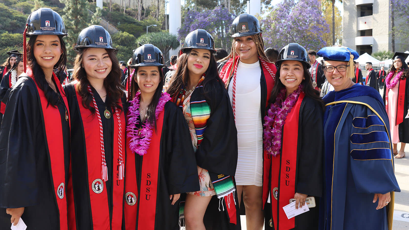 A group of CCEE graduates at commencement with a faculty member